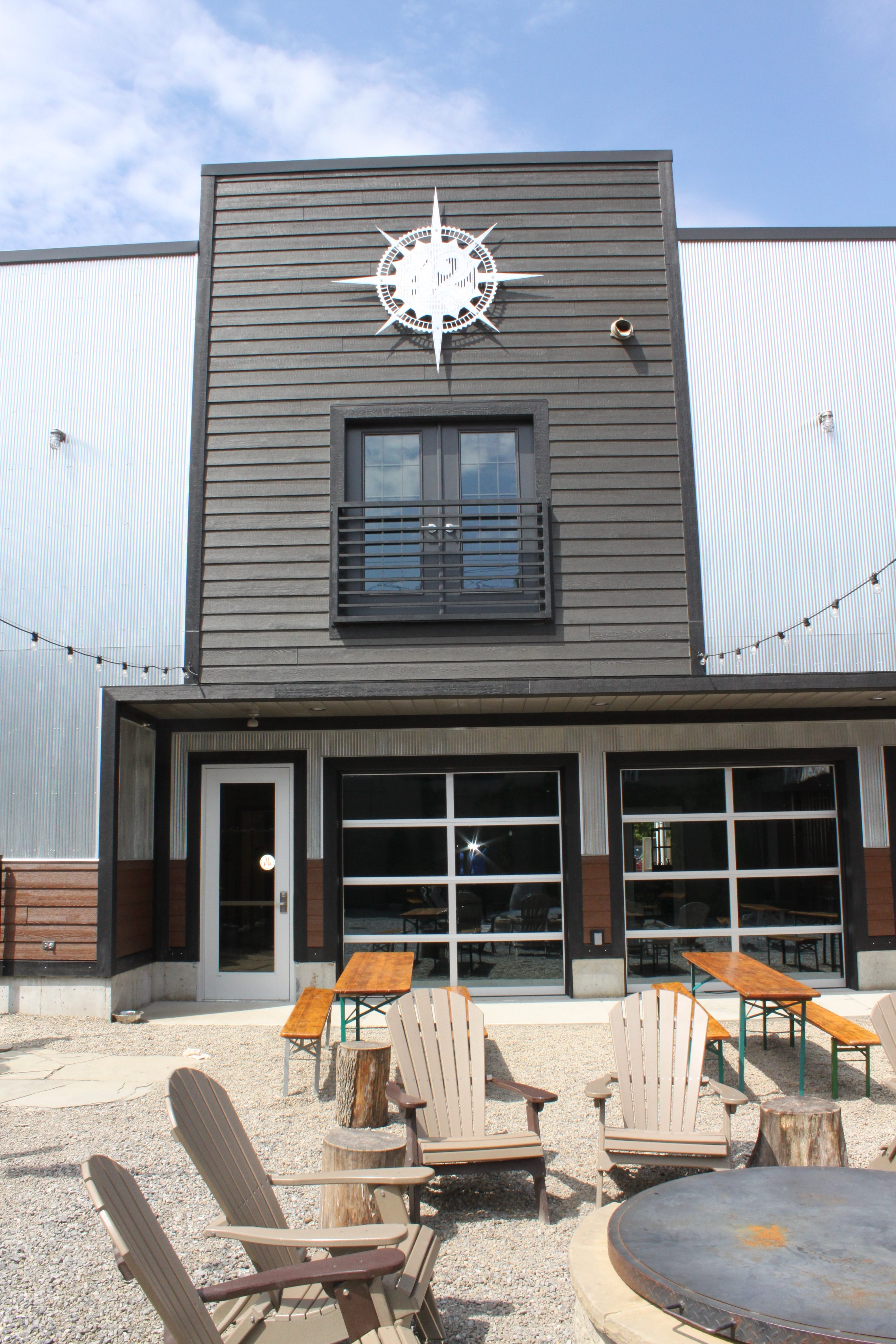 The exterior features metal siding in raw galvanized and black colors.