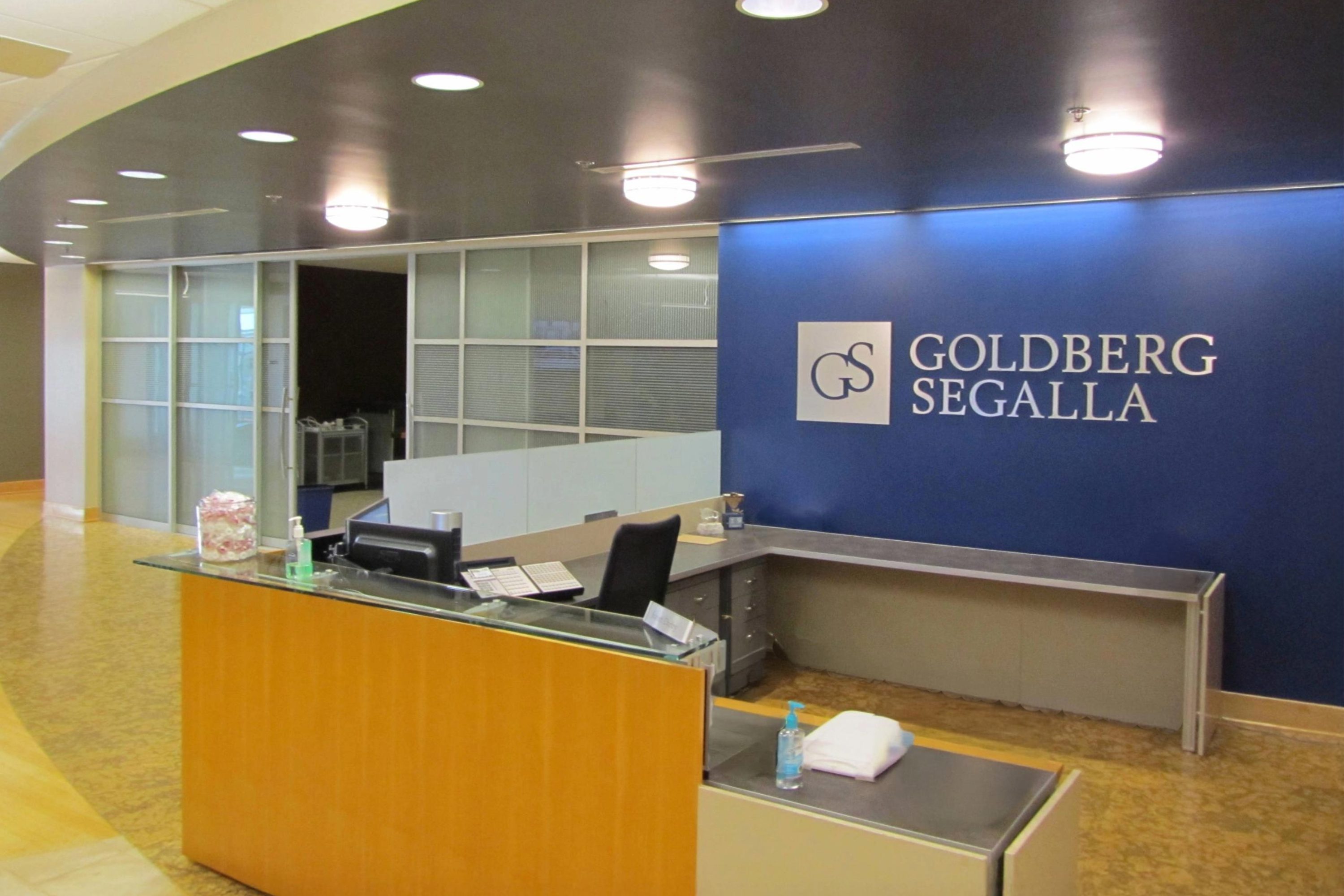 Front dest/reception area with logo wall.